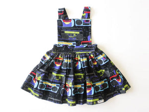 Girls pinafore dress in Boombox print.  Unique kids clothing by Worthy Threads clothing brand, available in matching sibling outfits!