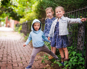 Girls STEM clothing: Three kids hanging off fence wearing styles featuring STEM print.  Perfect matching sibling outfits!