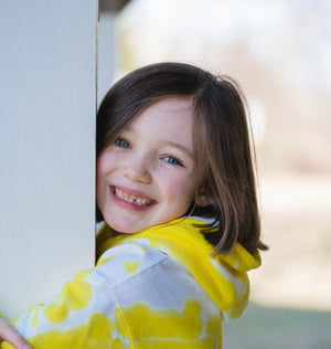 Girl modeling yellow tie dye hoodie sweatshirt