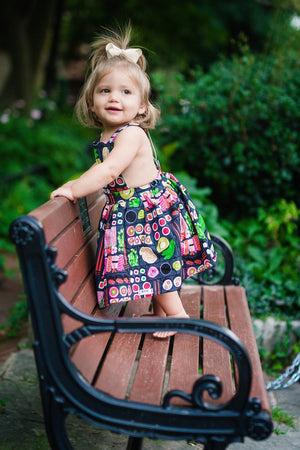 Unique baby clothes.  Toddler in sushi pinafore dress standing on park bench.  Matching sibling outfits available!