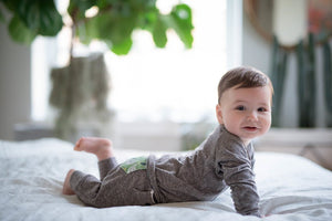 Unique Baby boy Clothes and sibling coordinating outfits.  Baby in grey loungewear set pushing up on bed.