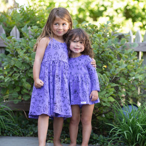 Sister matching outfits purple twirly dress and bubble romper