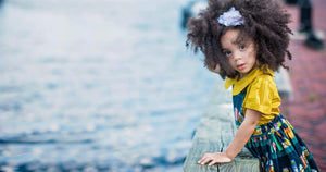girl in worthy threads pinafore and yellow top overlooking water
