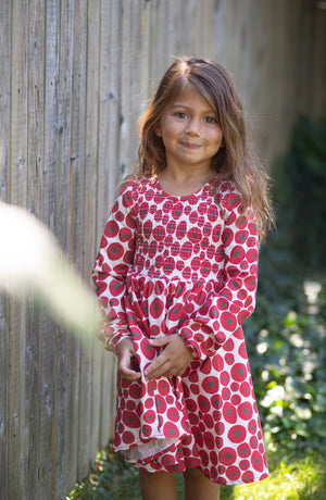 Model in tomato print dress