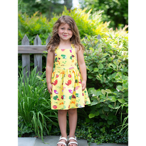 Toddler in girls tie back summer dress, yellow with veggie print