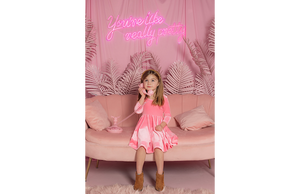 Model in candy pink twirly dress for girls