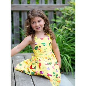 Candid of girl in yellow sundress with veggie print