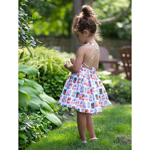 Back view of toddler in retro soda can print dress