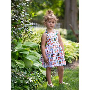 Model in girls summer tie back dress in retro soda print