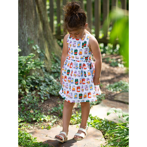 Model in girls summer tie back dress in retro soda can print