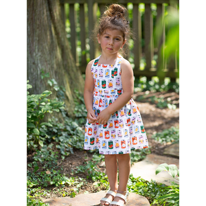 Girl in summery dress with retro soda bottle print