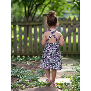 Back view of girls cross back twirly dress in neon leopard print