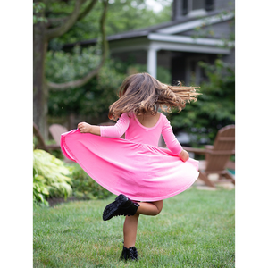 Toddler twirling in girls twirly dress pink candy stretch velvet