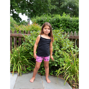 Toddler in hot pink biker shorts with dinosaur print