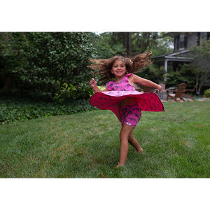 Toddler twirling in dinosaur matching outfit: biker shorts and twirly dress