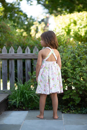 Back view of girls cross back in pink plants