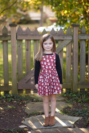 Girl modeling Christmas Santa’s pinafore dress
