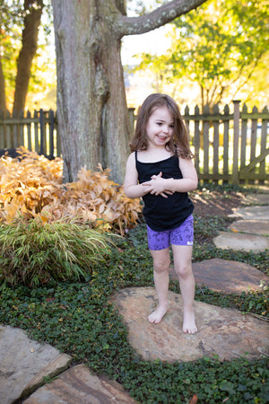 Toddler in purple STEM themed biker shorts