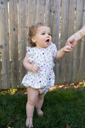 Baby bubble romper in 90s toys print