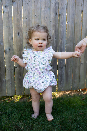 Baby modeling bubble romper in pink retro print