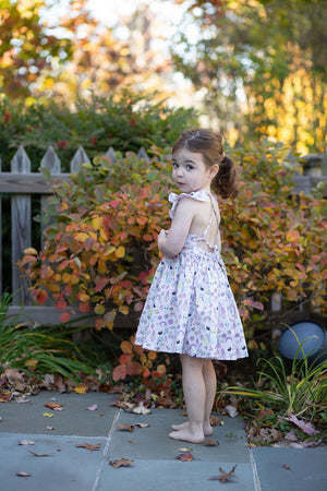 Model showing back of girls ruffle sleeve dress