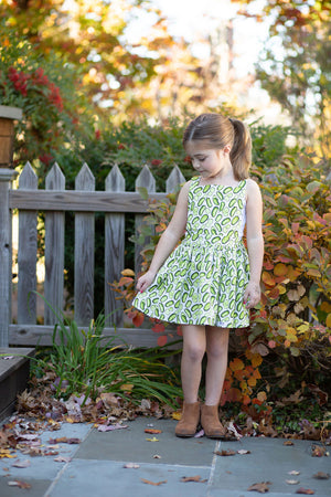 Model in girls pinafore dress with pickles print