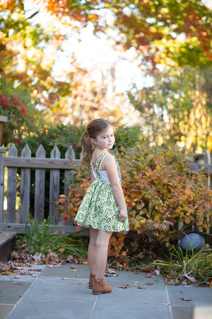 Girls pinafore dress in pickles print on odel