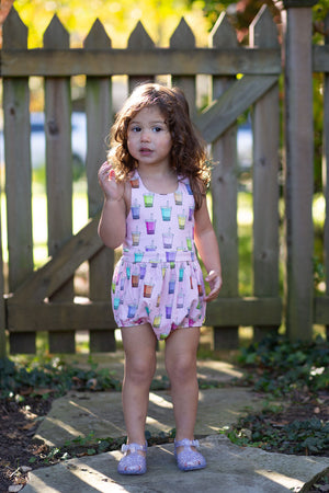 Toddler in cross back bubble romper in quirky boba print