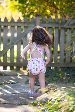 Back view of cross back baby bubble romper in pink boba print