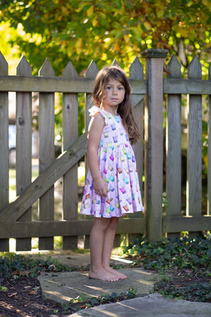 Girl modeling pink summer dress with Boba print