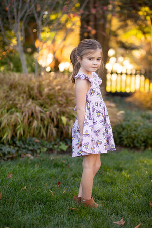 Girls ruffle sleeve dress in purple roller skates print