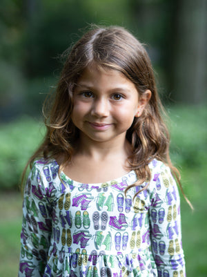 Close up of Toddler wearing girls twirly dress in retro funky sneakers print