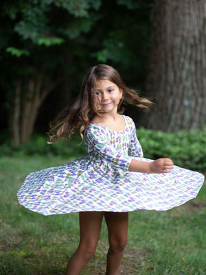 Toddler spinning in girls twirly dress in retro funky sneakers print