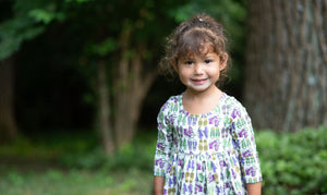 Toddler in baby bubble romper featuring retro funky sneakers print