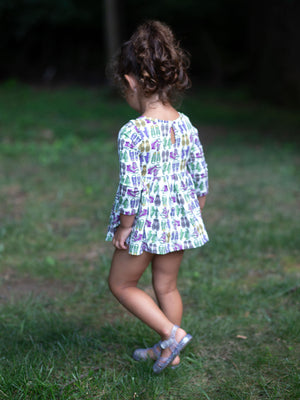 Back view of Toddler in baby bubble romper featuring retro funky sneakers print