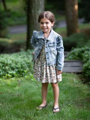 Toddler modeling girls puff sleeve denim jacket over pinafore dress