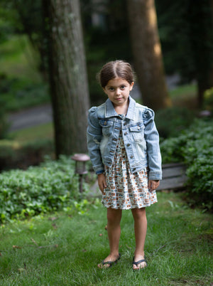 Toddler modeling girls puff sleeve denim jacket over pinafore dress, front view