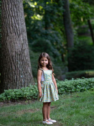 Toddler modeling girls pinafore dress in cheetah print, Apron dress