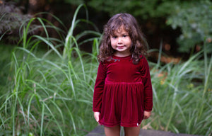 Christmas holiday velvet bubble romper with embroidery modeled by toddler, close up view