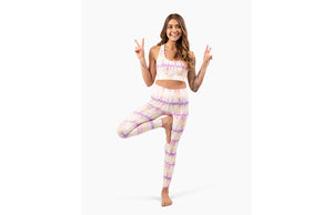 Model in matching activewear set: pastel tie dye leggings and sports bra