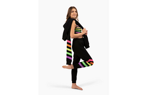 Model wearing matching black activewear loungewear set with neon stripes