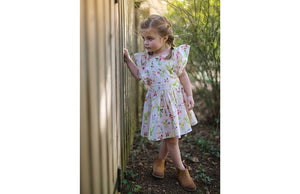 Girl modeling Vintage Inspired dress with ruffle sleeves