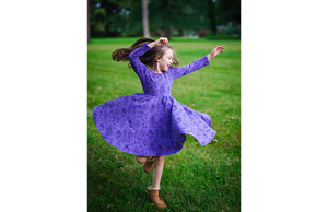 Girl spinning in robots twirly purple dress: stem clothing for girls